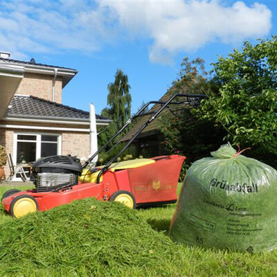 Rasenmäher mit Rasenschnitt und einem Grünabfall-Sack