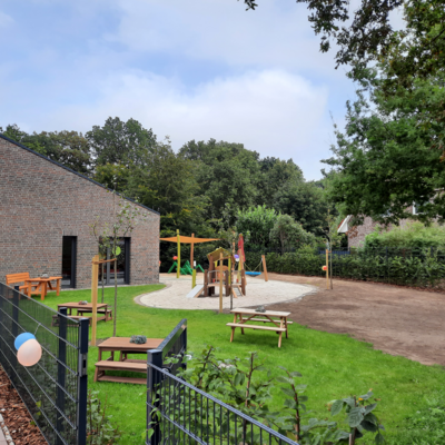 Garten mit Spielger&uuml;sten, davor ein Zaun