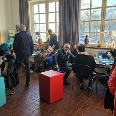 Menschen sitzen im Caf&eacute;.